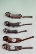 Four vintage silver plate naval bosuns whistles and another in copper and brass.