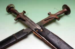 A brace of Indian Tulwar, characteristic steel hilts with disc pommels contained in their leather