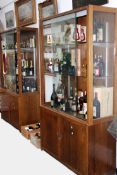 A pair of 1920s oak display cases with adjustable shelves.