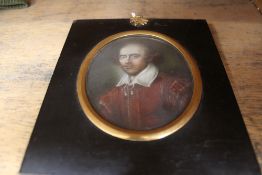 A 19th Century oval miniature portrait of a young man in red coat and white shirt, 102 x 84mm.