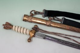 A German WWIII naval dagger with etched blade in brass scabbard. The hilt with eagle pommel, c/ knot