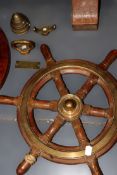 A small teak and bronze boat wheel. Together with a military shell timer and three other pieces.