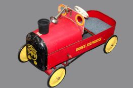 A vintage child’s tri-ang pedal car. Red paint with yellow lettering and detail. 78cm long.