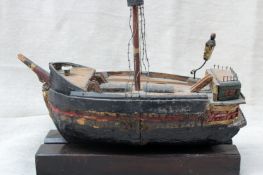 An antique Folk Art model of a galleon.