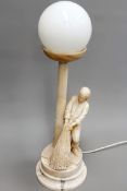 An Art Deco period carved alabaster table lamp in the form of a fisherman hauling nets. 51cm high (