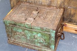 An early 19th Century iron strong box of panelled form. Relief decoration of recumbent lions.