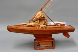 A vintage sail boat pond yacht of planked construction with rigging and sails. 55cm long.