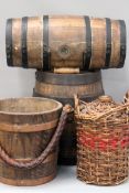 Two iron mounted small barrels. A leather covered rope handled marine fire bucket and a wicker cased