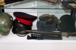 A German military steel helmet, a gas mask, two caps and a Russian military hat together with