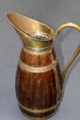 A coopered oak large jug. With brass mounts.