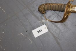 An early 19th Century English naval sword and scabbard. Foliate etched blade marked “Mackay