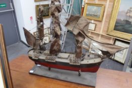 A rustic model of a three masted sailing vessel