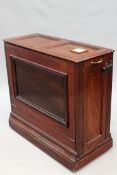 An Edwardian mahogany metamorphic chart or folio cabinet. Panelled form. Brass carrying handles on
