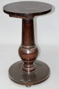 A substantial Edwardian “Capstan” form pedestal. Turned tapered column with circular base and top.