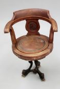 An early 20th Century “captains” chair on cast iron swivel base, the back carved with P & O
