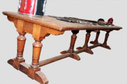 A large antique walnut “Galley” table. Two piece top detachable and standing on substantial two part