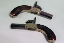 A pair of white metal framed percussion muff pistols, 1.5inch octagonal turn-off barrels, border and