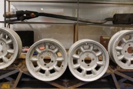 A group of four vintage mag alloy wheels. With 4 stud fixing. Together with a pair of adjustable car