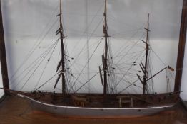 A cased hand built scale model of a three masted sailing vessel. Fully rigged. Case 35 x 28cm.