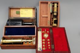 An early 20th Century brass small field microscope in mahogany case, a similar later example, a