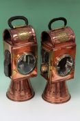 A pair of copper and brass candle lamps from a fire engine carriage with leather bound carrying