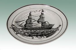 An early 19th Century creamware monochrome plate decorated with a black transfer scene of a