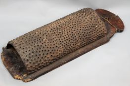 An unusually large antique colonial coconut grater. Perforated. Metal with shaped panel back.