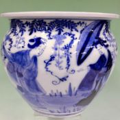 An Oriental blue and white jardiniere. With figural decoration and a similar large saucer dish