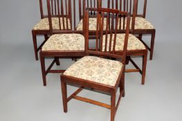 A set of six George III fruitwood dining chairs with drop in pad seats on square tapered forelegs.