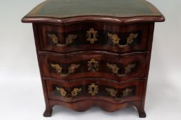 A Continental inlaid serpentine miniature chest fitted with three long drawers. 33cm wide x 23cm