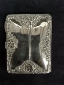 A late Victorian silver card case with embossed scrolled and floral designs. Birmingham 1897.