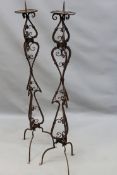 A pair of antique wrought iron Baroque style pricket floor standing candlesticks. Scroll work shafts