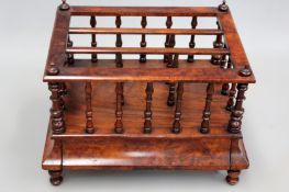 A Victorian walnut canterbury. Three division. Upper with spindle supports over a base drawer and