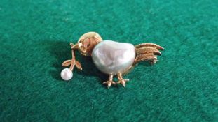 A chick brooch set with pearls.