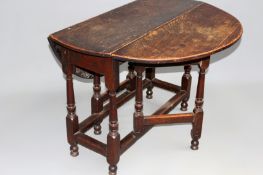 An 18th Century oak gateleg dining table, plain plank top over on turned legs and end drawer. 98cm.