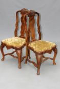 A set of ten 18th Century style walnut dining chairs. Each with carved crest over splat back, drop