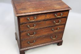 A George III mahogany and crossbanded chest of four graduated drawers on shaped bracket feet.