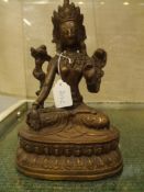 Two Tibetan figures of seated deities. One copper clad with silvered details. The other patinated