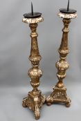 A pair of 18th Century Italian gilded pricket candlesticks with triform bases. 114cm high.