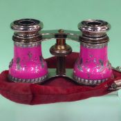 A pair of French pink enamel opera glasses with chased floral designs. Jumelle Duchess.  Cloth bag.