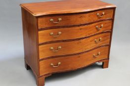 A George III mahogany serpentine fronted chest fitted with four long graduated drawers. 109cm wide x