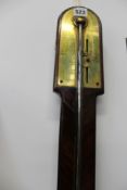 An early 19th Century mahogany stick barometer, Dolland, London. Arched top, engraved brass scale