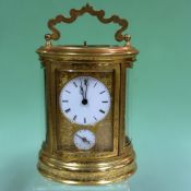 A late 19th Century French oval carriage clock with repeater action, twin train alarm with hour