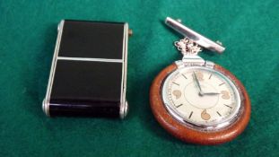 An Art Deco Cyma travelling watch. With black enamel case. Together with a Swiss cord leather