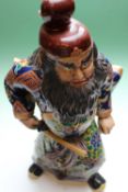 A Japanese figure of a Samurai warrior with sword drawn in ceremonial dress. 46cm high.