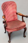 A gentleman’s mahogany armchair with out-swept arms terminating in eagle heads with acanthus