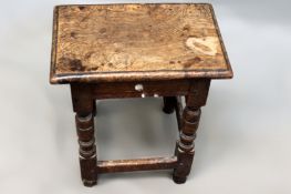 An antique and later oak joint stool. Moulded edge top on ring turned legs.