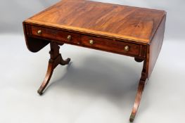 A Regency rosewood crossbanded and inlaid sofa table, two apron drawers. Trestle supports joined