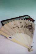 A late 19th Century Chinese ivory and silk fan with embroidered song birds on a flowering branch,