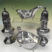 A pair of octagonal silver casters. London 1911. Maker Goldsmith and Silversmith. 21cm high. 15ozs.